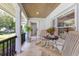 Charming porch with seating area overlooking lush landscape at 940 Lincoln Cir, Winter Park, FL 32789