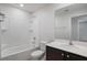 Bathroom featuring a shower and tub combo and a vanity with a large mirror at 1119 Union Ave, Mascotte, FL 34753