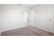 Bedroom with neutral walls and carpet, featuring a hallway view at 1119 Union Ave, Mascotte, FL 34753