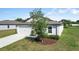 Single Gathering home boasts a tidy lawn, two-car garage and fresh landscaping, adding to its curb appeal at 1119 Union Ave, Mascotte, FL 34753