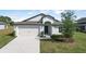 Charming single Gathering home with a well maintained lawn, two car garage, and a welcoming facade at 1119 Union Ave, Mascotte, FL 34753