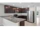Modern kitchen featuring granite countertops, stainless steel appliances, and dark cabinets at 1119 Union Ave, Mascotte, FL 34753