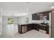 Spacious kitchen area with dark cabinets, granite countertops, and stainless steel appliances at 1119 Union Ave, Mascotte, FL 34753