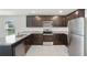 Modern kitchen with dark wood cabinets, stainless steel appliances, and granite countertops at 1119 Union Ave, Mascotte, FL 34753