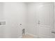 Laundry room with a white door and neutral colored walls at 1119 Union Ave, Mascotte, FL 34753
