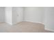 Bright, empty living area featuring neutral tile flooring and a doorway at 1119 Union Ave, Mascotte, FL 34753
