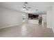 Open-concept living space showcasing tiled floors connecting the living area and kitchen at 1119 Union Ave, Mascotte, FL 34753