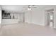 Large living area with tiled floors, leading to an open kitchen and hallway at 1119 Union Ave, Mascotte, FL 34753