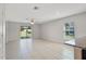 Bright living room featuring tiled floors, a ceiling fan, and sliding door access to the backyard at 1119 Union Ave, Mascotte, FL 34753