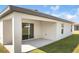 Covered patio features sliding glass door and ample space for outdoor seating or entertaining at 1119 Union Ave, Mascotte, FL 34753