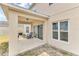 Covered patio area with comfortable seating, ideal for outdoor relaxation and enjoying the backyard views at 116 Green Branch Blvd, Groveland, FL 34736