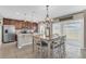 Open dining area featuring pendant lighting, a large dining table, and kitchen bar at 116 Green Branch Blvd, Groveland, FL 34736