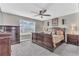Serene main bedroom featuring a sleigh bed, dark furnishings, and a ceiling fan at 116 Green Branch Blvd, Groveland, FL 34736