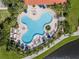 Aerial view of a uniquely shaped pool surrounded by lush landscaping at 11918 Nautica Dr, Orlando, FL 32827