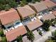 A high-angle view showcasing townhomes with screened patios, private garages, and red tile roofs at 11918 Nautica Dr, Orlando, FL 32827