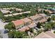 An aerial view capturing townhomes with tile roofs, screened patios, and manicured landscapes within a vibrant community at 11918 Nautica Dr, Orlando, FL 32827