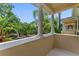 Balcony view featuring decorative columns and neighborhood greenery at 11918 Nautica Dr, Orlando, FL 32827
