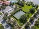 Aerial view of the basketball court near lake, clubhouse and pool surrounded by mature trees and landscaped grounds at 11918 Nautica Dr, Orlando, FL 32827