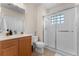 Bathroom with a modern shower, a toilet, and a vanity, all illuminated by contemporary lighting at 11918 Nautica Dr, Orlando, FL 32827