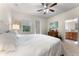 Bedroom featuring natural light, white linens, and ensuite bathroom access at 11918 Nautica Dr, Orlando, FL 32827