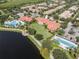Aerial view of the clubhouse featuring pool, lakefront, and meticulously landscaped grounds at 11918 Nautica Dr, Orlando, FL 32827