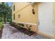 Side entrance to townhome with white door, brick walkway, and well maintained landscaping at 11918 Nautica Dr, Orlando, FL 32827