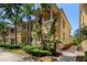 Charming yellow townhome featuring lush tropical landscaping and a welcoming entrance at 11918 Nautica Dr, Orlando, FL 32827