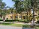 Charming yellow townhome with mature landscaping and palm trees in a well-maintained community at 11918 Nautica Dr, Orlando, FL 32827