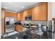 Close up of kitchen featuring black granite countertop, stainless steel appliances, and light wood cabinets at 11918 Nautica Dr, Orlando, FL 32827