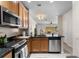 Kitchen with stainless steel appliances, black countertops, and a view into the living room at 11918 Nautica Dr, Orlando, FL 32827