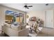 Bright living room with neutral décor, ceiling fan, and sliding glass doors to an outdoor space at 11918 Nautica Dr, Orlando, FL 32827