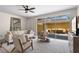 Bright living room with neutral décor, ceiling fan, and a view of the screened-in patio at 11918 Nautica Dr, Orlando, FL 32827