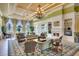 Expansive lounge area featuring elegant chandeliers, cozy fireplace, comfortable seating, and views of outdoor scenery at 11918 Nautica Dr, Orlando, FL 32827