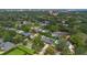 Drone view of homes showcasing the neighborhood's well-manicured lawns, mature trees, and proximity to water features at 1245 Munster St, Orlando, FL 32803