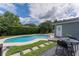 Backyard featuring a sparkling pool with lush landscaping and an outdoor dining area at 1245 Munster St, Orlando, FL 32803