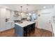 Modern kitchen with a center island, white cabinetry, stainless steel appliances, and hardwood floors at 1245 Munster St, Orlando, FL 32803