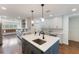Stylish kitchen with a large island, stainless steel appliances, and sleek white cabinetry throughout at 1245 Munster St, Orlando, FL 32803
