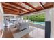 Comfortable living room with wood ceiling, built-in shelves, and sliding glass doors to the pool at 1245 Munster St, Orlando, FL 32803