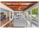 Open living room with wood ceiling, built-in shelves, and view to other rooms at 1245 Munster St, Orlando, FL 32803
