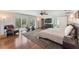 Luxurious primary bedroom with access to patio, exercise equipment, and a private bathroom with modern finishes at 1245 Munster St, Orlando, FL 32803