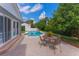 Outdoor patio with table and chairs, overlooking the pool and landscaped backyard at 1245 Munster St, Orlando, FL 32803