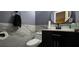 Stylish half-bathroom featuring modern fixtures, white tile, and a sleek vanity at 1302 Center St, Ocoee, FL 34761