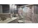 Modern bathroom with marble-look shower, glass doors, and a sleek vanity at 1302 Center St, Ocoee, FL 34761