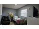 Bedroom with a bed, leather recliner, and vinyl flooring at 1302 Center St, Ocoee, FL 34761