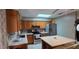 Open kitchen with stainless steel appliances, light countertops, an island with seating at 1302 Center St, Ocoee, FL 34761