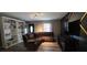 Comfortable living room featuring a large sectional sofa, bookshelves, and wood-look flooring at 1302 Center St, Ocoee, FL 34761