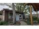 View of the brown exterior of the backyard shed with white trim and a walkway to the door at 1302 Center St, Ocoee, FL 34761