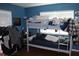 Image of a blue bedroom featuring a bunk bed, posters, and natural light at 1364 Gainesville Dr, Deltona, FL 32725