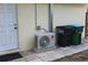 Exterior view showing the AC unit and garbage containers near the back door of the home at 1364 Gainesville Dr, Deltona, FL 32725