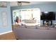 View of the bedroom through a large open doorway, featuring a comfy gray couch and natural light at 1364 Gainesville Dr, Deltona, FL 32725